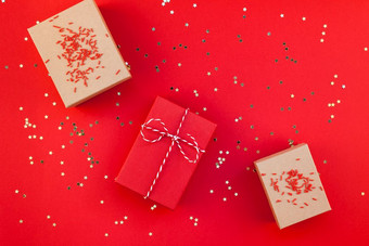 新一年圣诞节礼物包装丝带平躺前视图圣诞节假期庆祝活动手工<strong>制作</strong>的礼物盒子红色的纸金闪光背景<strong>模板</strong>模型为问候卡文本设计