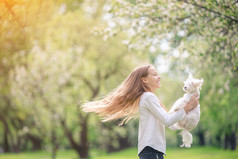 快乐小女孩与狗有有趣的的公园小微笑女孩玩和拥抱小狗的公园