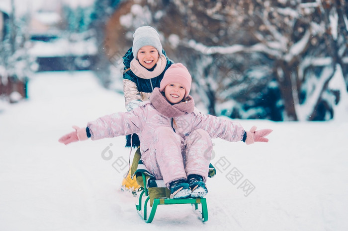 小可爱的女孩享受雪橇骑孩子们滑雪橇和玩在户外雪家庭假期圣诞节夏娃在户外可爱的小快乐女孩滑雪橇冬天雪一天