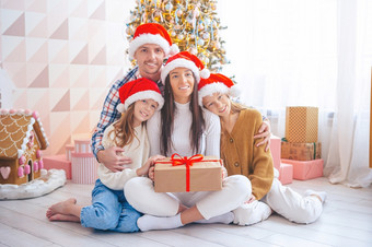 家庭四个圣诞节假期首页快乐圣诞节和快乐假期快乐年轻的家庭与孩子们持有圣诞节礼物