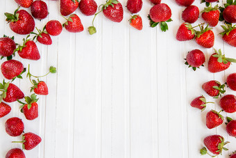 成熟的红色的<strong>草莓</strong>分散白色木表格背景与<strong>草莓</strong>的地方为文本成熟的红色的<strong>草莓</strong>分散白色木表格背景与<strong>草莓</strong>