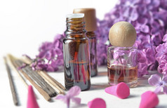 瓶至关重要的石油和香与紫色的淡紫色花背景
