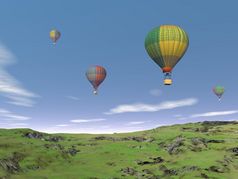 几个色彩斑斓的气球飞行的蓝色的天空在绿色草原