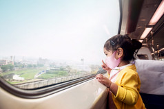旅行新正常的生活方式概念快乐孩子们穿外科手术保护面具内部火车而旅行与她的父坐着宽玻璃窗口取视图