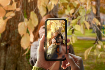 采取照片通过智能手机年轻的人使用移动电话采取照片为朋友<strong>户外</strong>公园<strong>模型</strong>屏幕与数字相机的相同前面视图