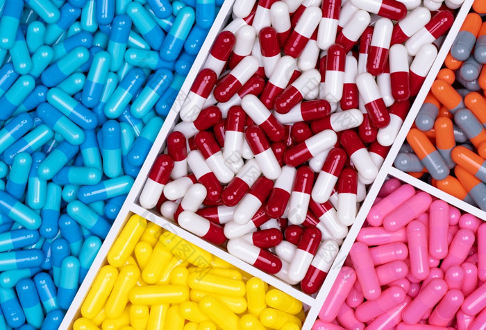前视图色彩斑斓的胶囊药片塑料托盘制药行业医疗保健和医学制药学概念维生素和补充胶囊完整的框架明亮的颜色胶囊药片