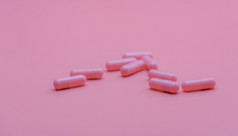 粉红色的胶囊药丸粉红色的背景维生素和补充在线药店药店商店横幅制药行业女人rsquo健康保险概念药片为爱和快乐生活