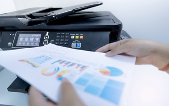 办公室工人打印纸多功能激光打印机复制打印扫描和传真机办公室文档和纸工作打印技术模糊手持有印刷纸扫描仪设备