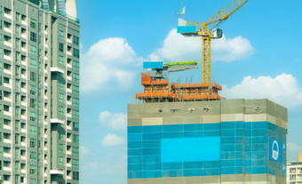 建设网站与起重机和摩天大楼建筑真正的房地产行业起重机建设网站项目发展真正的房地产公司概念建设起重机工作对蓝色的天空