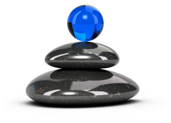 两个黑色的鹅卵石堆放在白色背景与蓝色的玻璃球的前概念上的象征幸福和谐放松概念鹅卵石堆栈