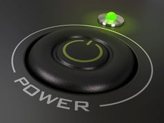 权力按钮个人电脑的绿色领导光图像在黑色的背景权力按钮开始个人电脑