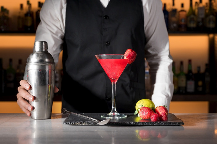专家酒保准备美味的草莓鸡尾酒高质量摄影专家酒保准备美味的草莓鸡尾酒