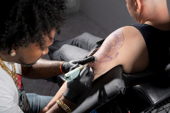 专业非洲美国纹身艺术家使纹身<strong>客户端</strong>手臂高质量摄影专业非洲美国纹身艺术家使纹身<strong>客户端</strong>手臂