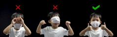 如何穿医疗脸面具正确从亚洲小男孩如何穿脸面具正确的和的错误的冠状病毒预防新冠病毒概念