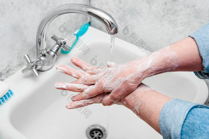 女人非常小心翼翼地洗手与肥皂在疫情冠状病毒女人非常小心翼翼地洗手与肥皂在疫情冠状病毒
