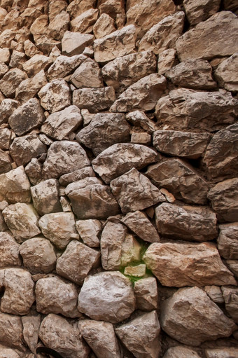 古老的岩石墙纹理美丽的镜头耀斑背景老岩石露头人行道上明亮的阳光警告语气的老墙chengzi村云南中国纹理背景