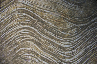 棕色（的）和灰色的排石头纹理背景自然波浪纹理背景与波浪行就像写作混凝土装饰表面特写镜头变形取照片前视图