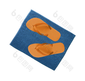 一对橙色拖鞋蓝色的地毯孤立的一对橙色拖鞋蓝色的地毯