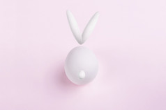 插图复活节兔子使鸡蛋软粉红色的背景快乐复活节兔子