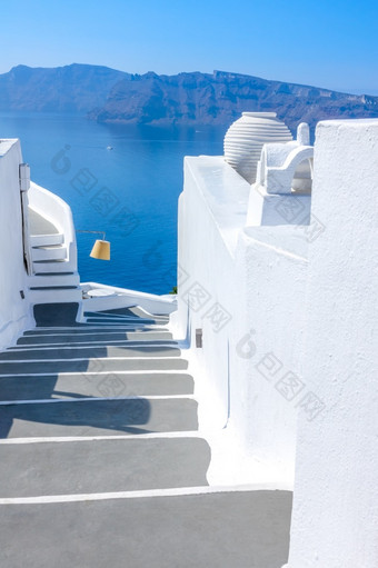 希腊阳光明媚的夏天一天的岛圣托里尼岛传统的白色楼梯与灰色的步骤俯瞰的海白色楼梯的海与灰色的步骤