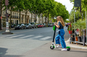 法国夏天阳光明媚的一天巴黎女孩电踏板车街十字<strong>路口</strong>女孩电踏板车的十字<strong>路口</strong>巴黎