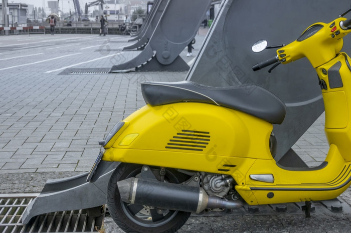 荷兰渡船码头阿姆斯特丹中央黄色的踏板车巨大的铁支持黄色的踏板车铁支持