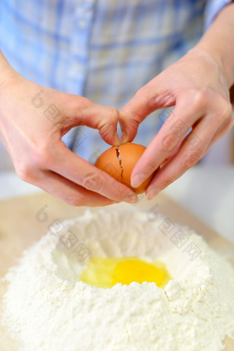 烹饪女人使面团添加鸡蛋面粉