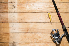 钓鱼杆与黄色的钓鱼诱饵木板材