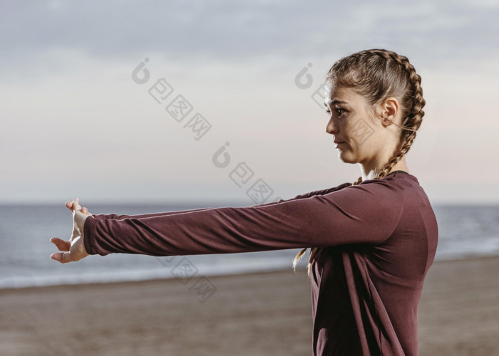 一边视图运动女人伸展运动海滩