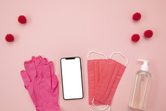 前视图粉红色的医疗面具手套与空白电话