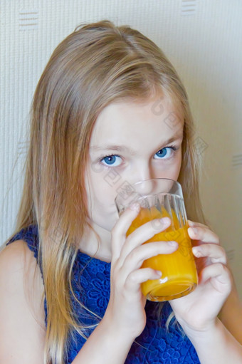 可爱的女孩与金发碧眼的长头发喝饮料