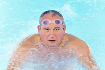 肖像大脂肪男人。游泳池水