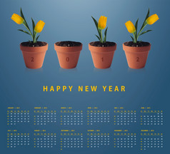 新一年日历与概念上的图像黄色的郁金香容器