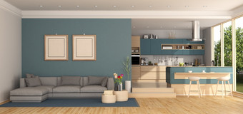 蓝色的生活房间与灰色的沙发和现代厨房背景呈现蓝色的生活房间与厨房背景