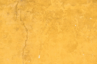 老concrette墙覆盖黄色的画饱经风霜的粉刷纹理背景