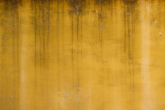 老饱经风霜的黄色的画粉刷墙纹理