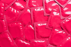 避孕套背景前视图粉红色的箔包装乳胶橡胶避孕套背景