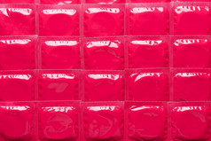 避孕套粉红色的箔包装背景纹理前视图平躺