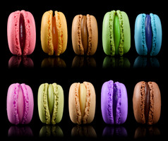 甜蜜的色彩斑斓的马卡龙孤立的黑色的背景法国蛋白杏仁饼分类集