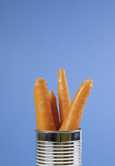 罐头胡萝卜与蓝色的背景细节新鲜的和生蔬菜健康的生活健康的食物