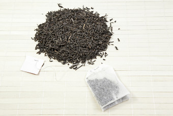 叶子和黑色的茶袋细节日本茶和输液袋东方茶饮料