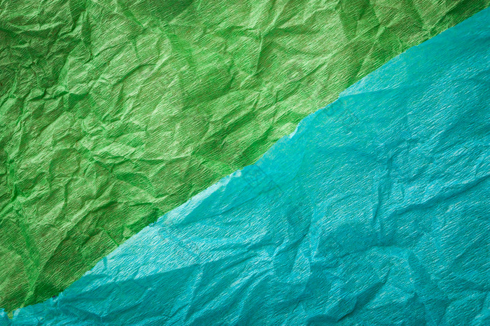 皱巴巴的多色的真正的色彩斑斓的纸表纹理背景绿色青色多色的皱巴巴的真正的生动的纸表纹理背景绿色青色