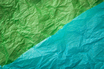 皱巴巴的多色的真正的色彩斑斓的纸表纹理背景绿色青色多色的皱巴巴的真正的生动的纸表纹理背景绿色青色