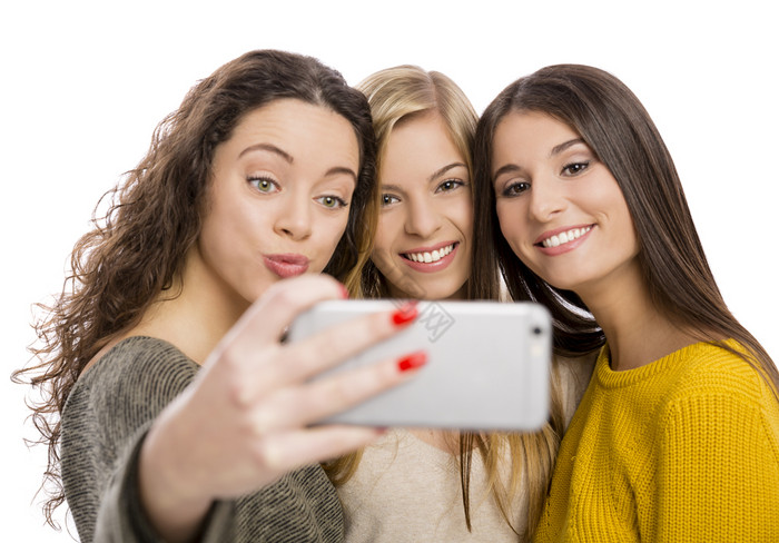 青少年女孩与智能手机采取自拍图片