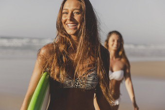 最好的朋友享受的<strong>夏天</strong>走的海滩与冲浪板