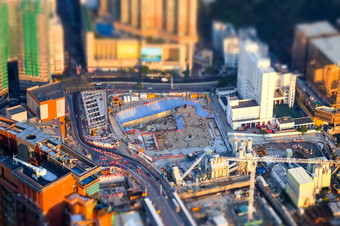 倾斜转变模糊效果令人惊异的空中城市景观视图与起重机工作建筑建设在香港香港摘要未来主义的城市景观与现代摩天大楼
