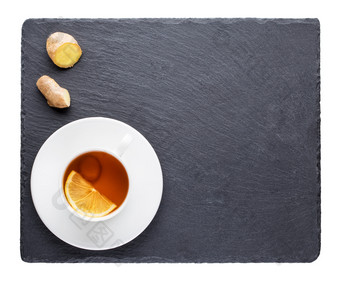 茶与的柠檬和姜根板岩黑板上孤立的白色背景茶与的柠檬和姜根板岩黑板上