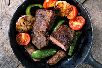 开胃的牛肉牛排与蔬菜铸铁煎锅木表格拍摄从的前的概念健康的自然食物开胃的牛肉牛排与蔬菜