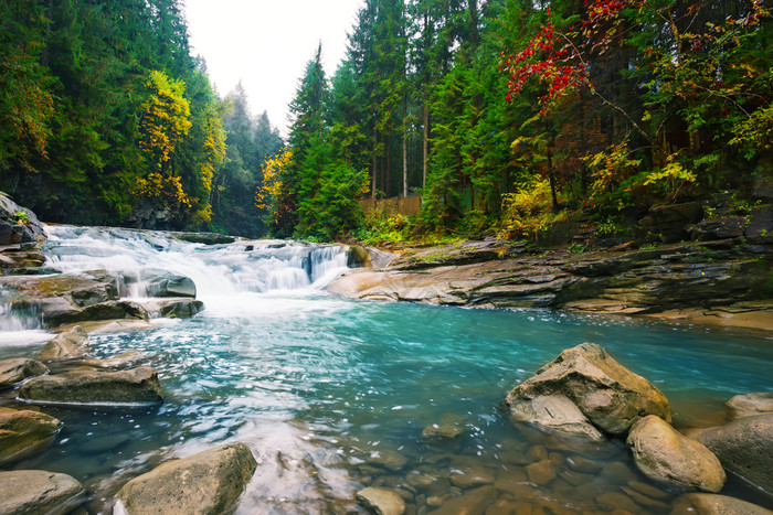 瀑布山河与蓝色的水的森林在明亮的树瀑布山河与蓝色的水