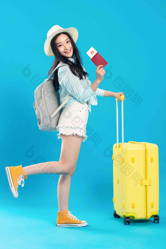 拿着行李箱去旅行的年轻女孩时尚高端照片